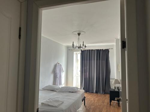 a bedroom with a white bed and a window at Minimalist 2-room Apartment in Aktobe