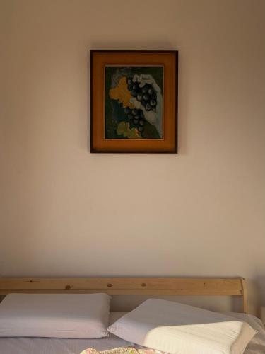 a picture on the wall above a bed at Silvia Miotto's Guesthouse in Guia