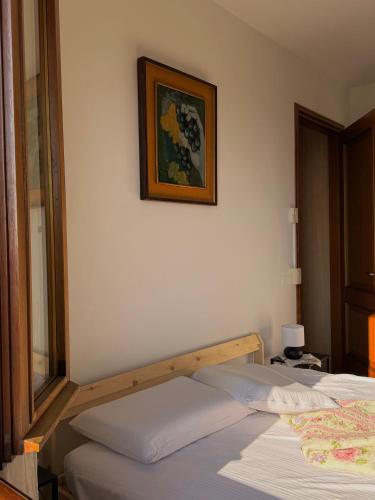 a bedroom with two beds and a picture on the wall at Silvia Miotto's Guesthouse in Guia