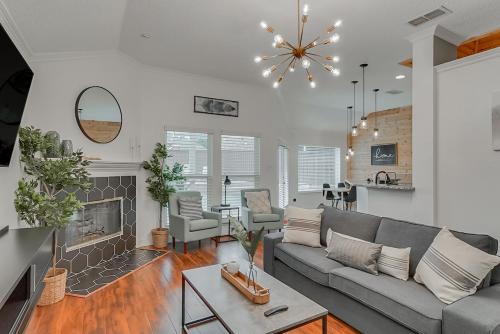 a living room with a couch and a fireplace at Elegant 5BR Retreat w Private Pool & Game Room in Mesquite