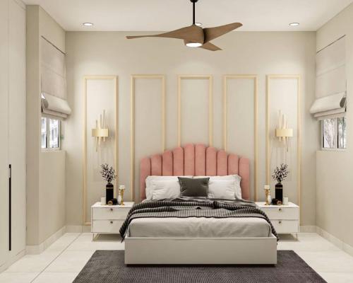 a bed with a pink headboard in a bedroom at Aizaz Villa in Peshawar