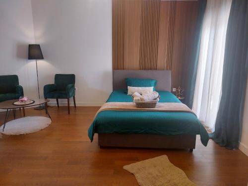 a bedroom with a bed with a basket on it at Aria Apartmani in Podgorica