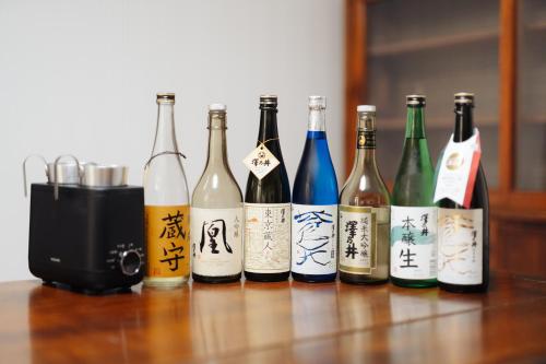 a group of bottles of wine sitting on a table at Tokyo Sake House in Ome
