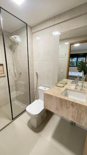 a bathroom with a toilet and a sink and a shower at Urban Stay Botanic in Goiânia