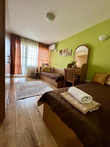 a bedroom with a bed and a living room at Radetsky Apartment with FREE Private Parking in Haskovo