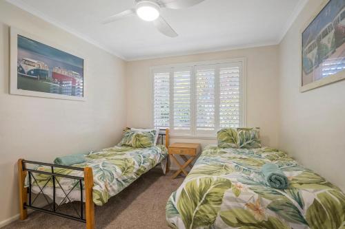 a bedroom with two beds and a window at Francis 31 in Port Macquarie