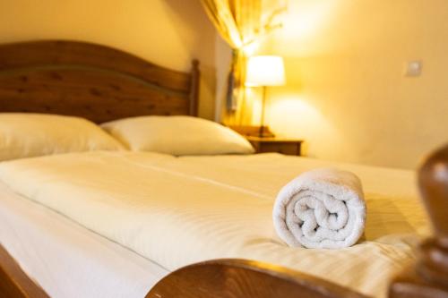a bed with a towel on top of it at Apartments Belopeški Dvori in Kranjska Gora