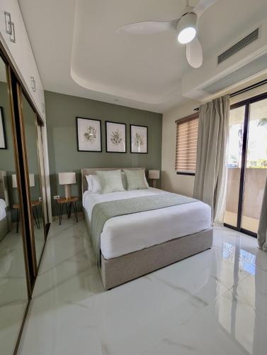 a bedroom with a large white bed and green walls at Salt & Breeze Villa in Priory