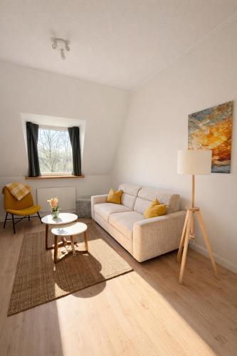 a living room with a couch and a table at Altbau Apartment mit toller Terrasse in Mülheim an der Ruhr