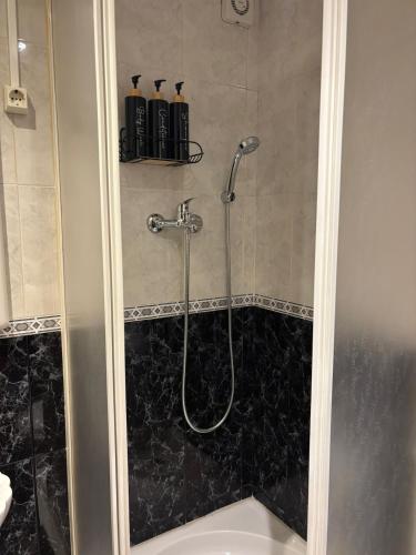 a bathroom with a shower with a bath tub at Setúbal Sunset Apartment in Setúbal