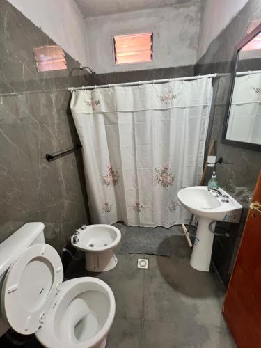 a bathroom with a toilet and a sink at Casa en la Puntilla 2 in Belén