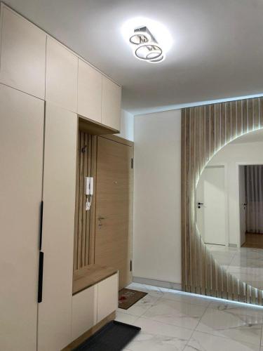 a living room with a mirror and a hallway at Tiffany Delux in Banja Luka