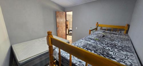 a small bedroom with a bed and a mattress at Rancho citrus in Coruripe