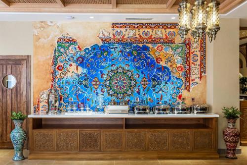 a wall with a blue and red mural on it at Farovon Tashkent Boutique Hotel in Tashkent