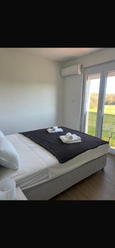 a bedroom with a bed with two towels on it at Rados Villa Flora in Fažana