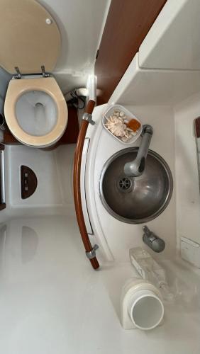 a small bathroom with a toilet and a sink at Каюта in Kotor