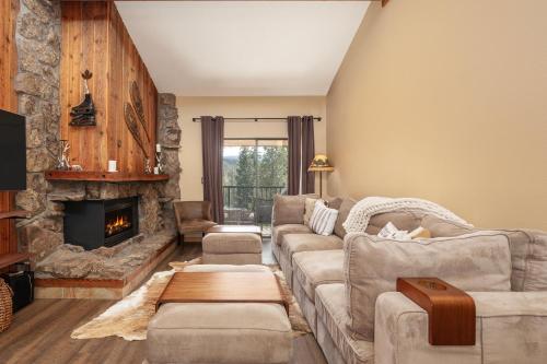 a living room with a couch and a fireplace at Beaver Village Unit #2031 in Winter Park