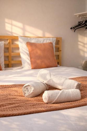 a pair of towels sitting on top of a bed at Le Royal Colbert - Hyper Centre - Cozy & Elegant in Tours