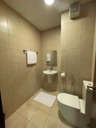 a bathroom with a toilet and a sink at قرية الراحه مرسى زايد in Al Burj