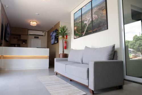 a living room with a couch and a table at Hotel Jaiba Premium in Terra Fôfa