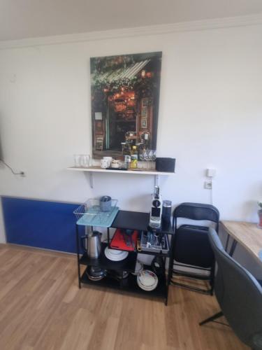 a room with a counter and a table and a chair at Rax-Basecamp 24 in Reichenau