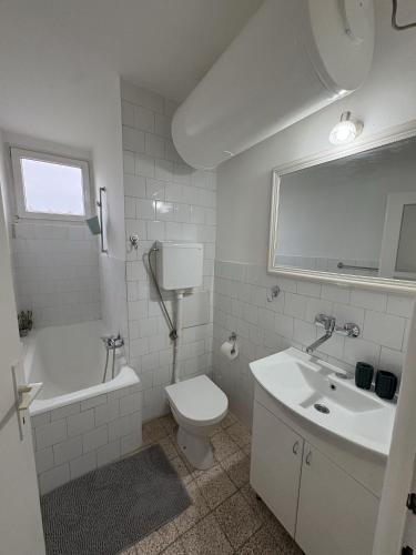 a bathroom with a sink and a toilet and a bath tub at City Vibes in Subotica