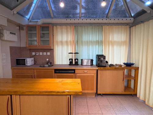 a kitchen with wooden cabinets and a counter top at HausHarder Rooms in Gommiswald