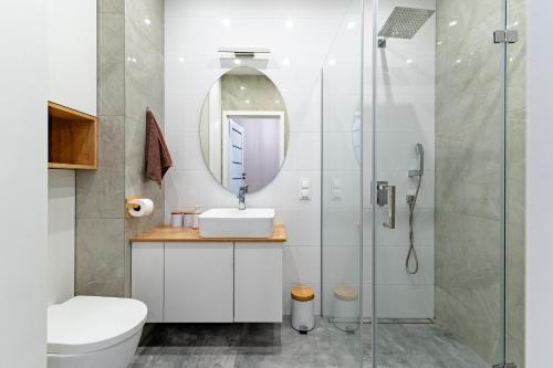 a bathroom with a sink and a shower at Apartament Pirat in Ostróda
