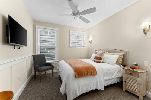 a bedroom with a bed and a tv and a chair at 8609 Landis Ave, Condo 201 in Sea Isle City