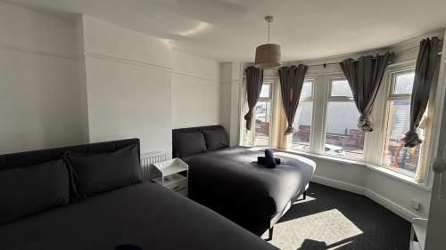 a bedroom with a bed and a window at Tranquil Hideaway with Hot Tub and Pool Table in Cardiff