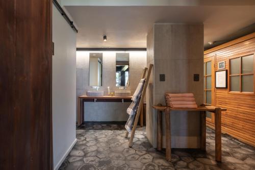 a bathroom with a sink and a counter with a mirror at Cascadas Hotel in Puerto Octay