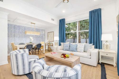 a living room with a couch and chairs and a table at Designer condo w oceanfront & walk to Worth Ave in Palm Beach