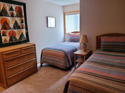 a bedroom with two beds and a dresser with a dresser at 4 Approach Lane in Sunriver