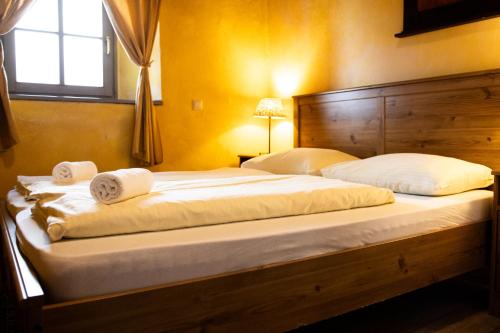 a bedroom with a large bed with towels on it at Apartments Belopeški Dvori in Kranjska Gora