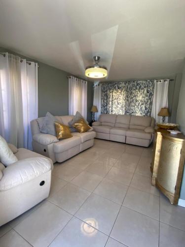 a living room with two couches and a couch at Caribbean Staycation in Portmore