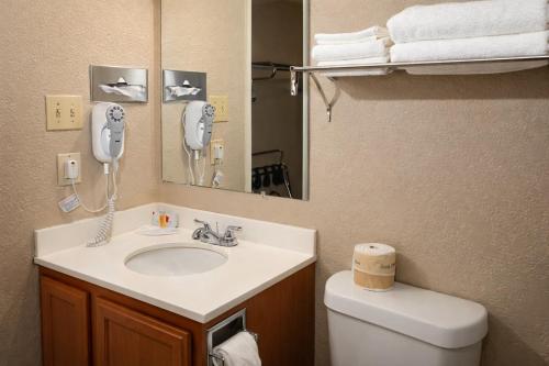 a bathroom with a sink and a phone on the wall at Townhouse Super Gallup - I-40 in Gallup