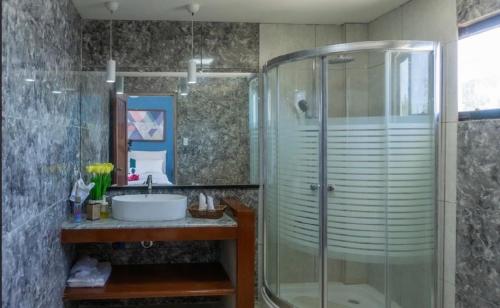 a bathroom with a shower and a sink at Virmuda Villa Rental in Po-oc