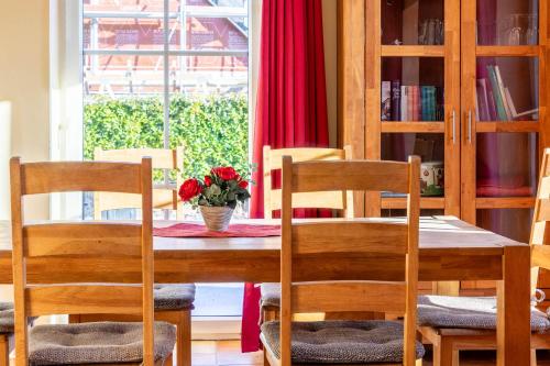a dining room with a table and chairs and a window at Ferienhaus Mandy in Wohlenberg