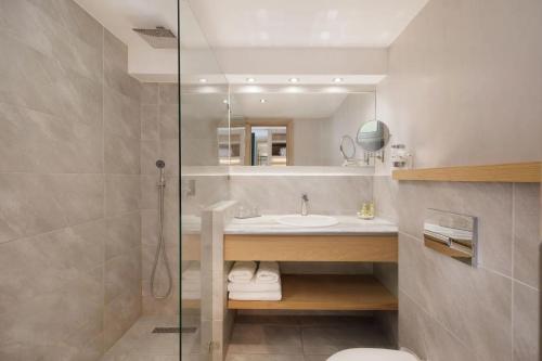 a bathroom with a sink and a mirror at Marilena Sea View Hotel in Pyrgi