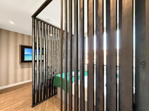 a room with a iron fence with a green bench at Luxury Apartments in Milton Keynes