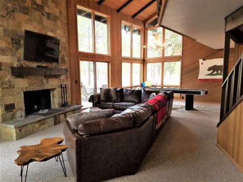 a living room with a couch and a ping pong table at 4 Spyglass Lane in Sunriver