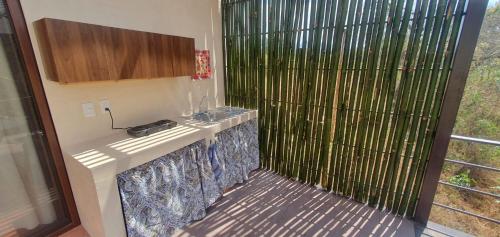 a kitchen with a sink and a shower with a window at Casa Catonalco in Xalmolonco