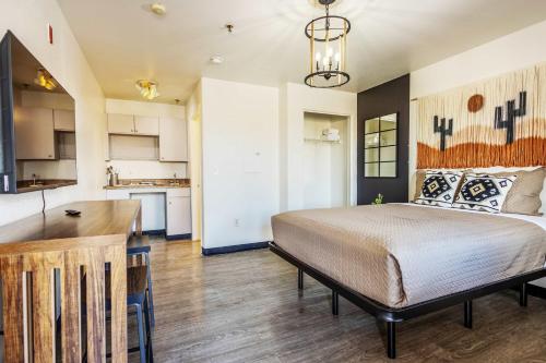 a bedroom with a bed and a kitchen at Tolleson Studio Pool & Gym Access for 2 in Tolleson