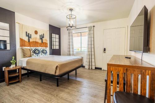 a bedroom with a bed and a television in it at Tolleson Studio Pool & Gym Access for 2 in Tolleson