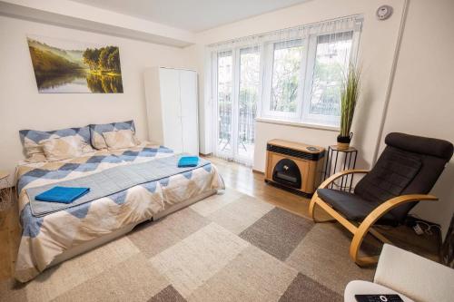 a bedroom with a bed and a chair at Tarján Gyöngye in Salgótarján