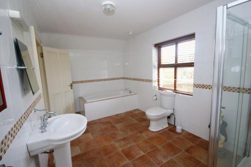 a bathroom with a toilet and a sink and a shower at Laurel Lodge in Virginia