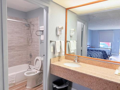 a bathroom with a sink and a mirror at Knights Inn Ruther Glen in Ruther Glen