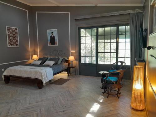a bedroom with a bed and a large window at Gala Da Vittoria in Capelas