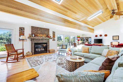 a living room with a couch and a fireplace at Voyagers Paradise in Gualala