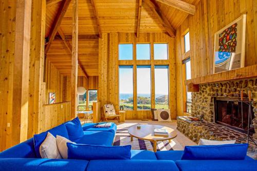 a living room with blue couches and a fireplace at Breakers Hideaway in Sea Ranch